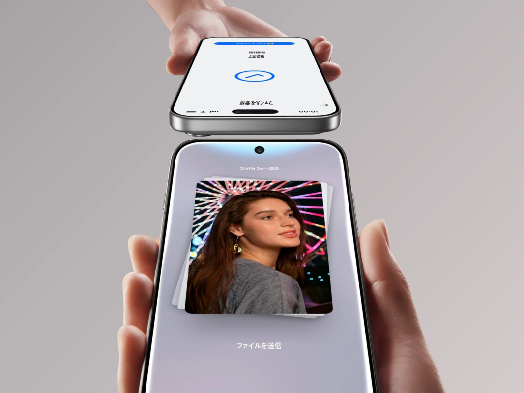 二台のスマートフォンが上下に配置され、下のスマホから上のスマホへ写真が転送されている様子が描かれています