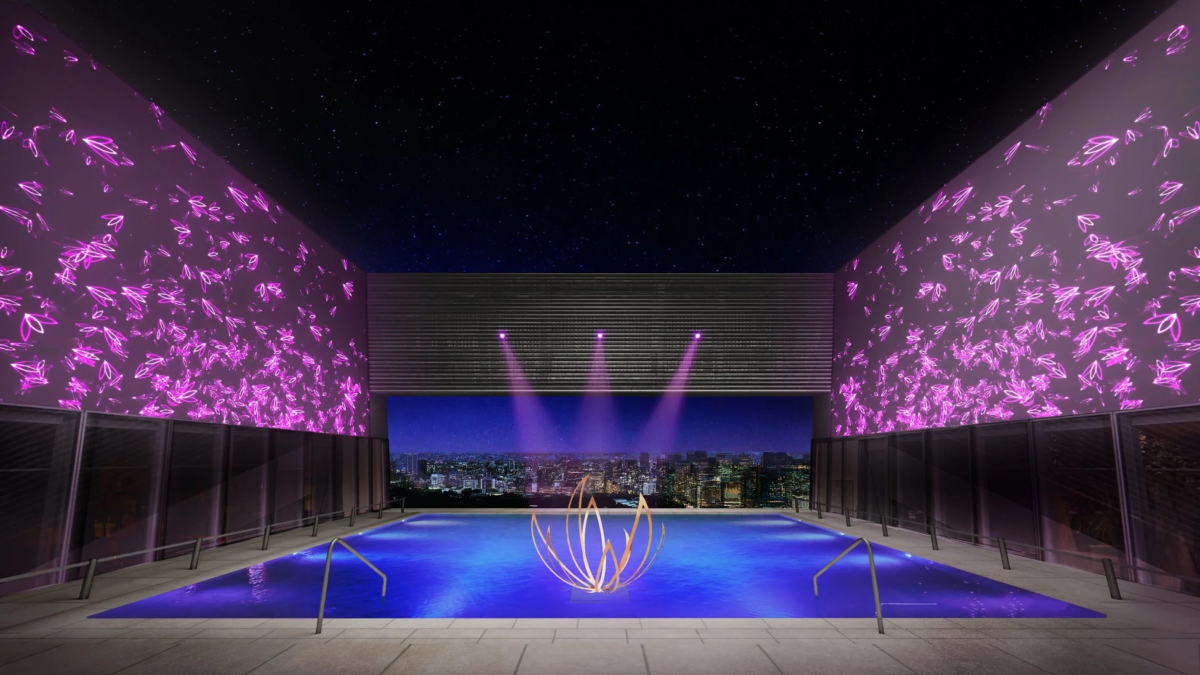 美しい夜景と星空が広がる屋内プール。ピンクの葉の形をした光で飾られた壁と、水面に浮かぶ金色の蓮のオブジェが幻想的でラグジュアリーな雰囲気を醸し出しています。