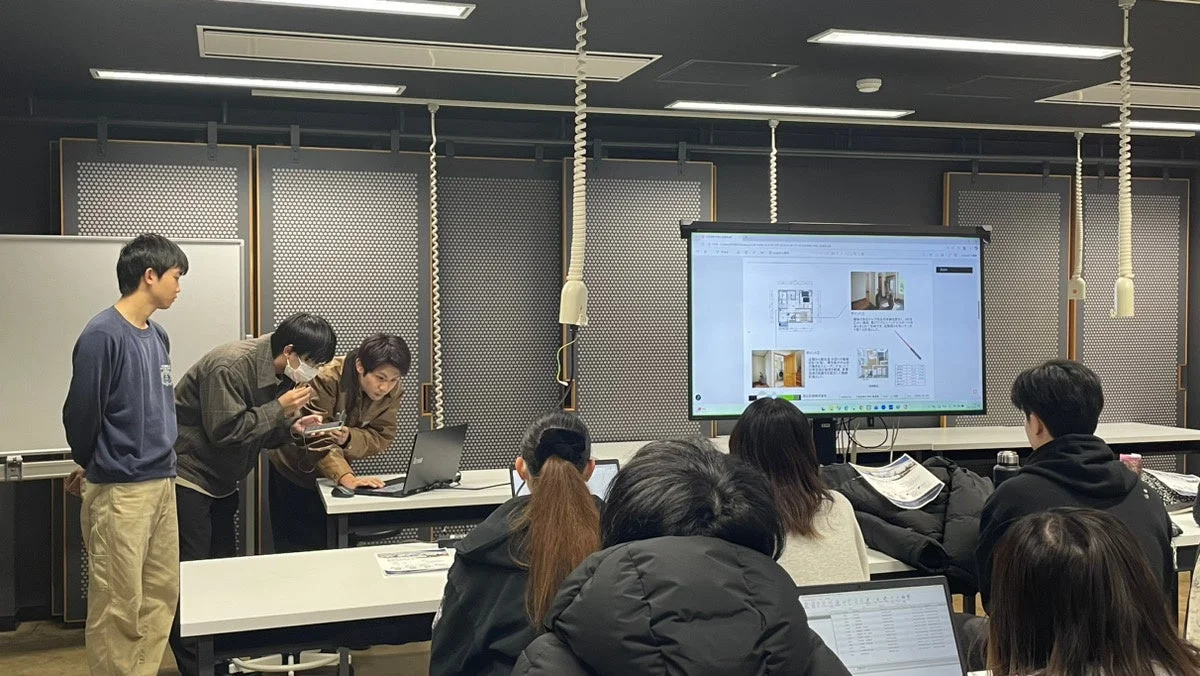 モニターを見ながら議論する学生たち