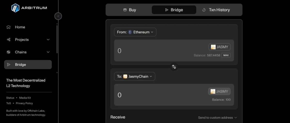 Arbitrumのブリッジ機能のユーザーインターフェースで、EthereumからJasmyChainへJASMYトークンを転送する設定画面が表示されています。現在のトークン残高も確認できます。